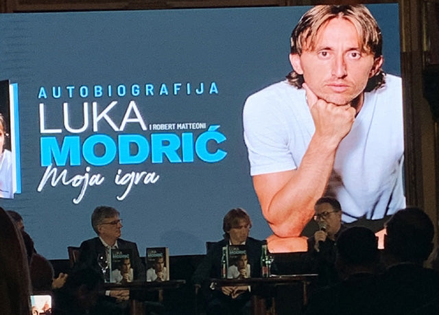 Panel at the launch of Luka Modrić's autobiography, with the book cover on the stage backdrop.